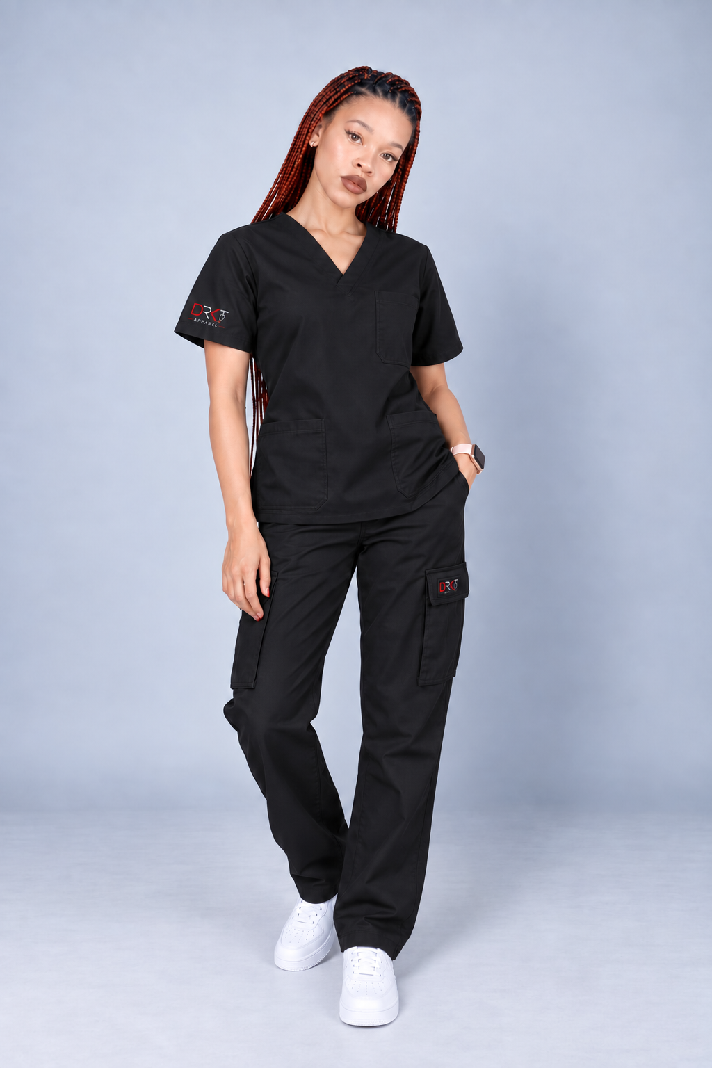 The same DRKT model wearing black scrubs with straight-leg bottoms